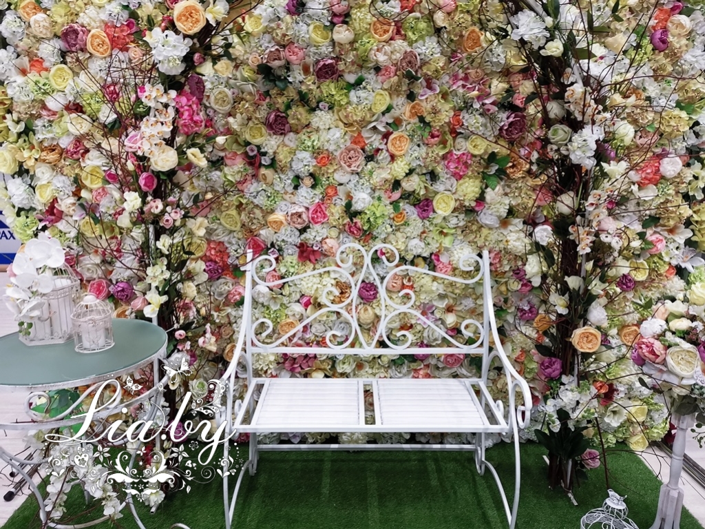 Садовый диванчик и большая цветочная арка на фоне цветочной стены - фотозона