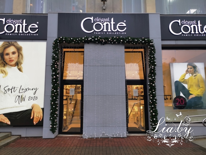 украшение магазинов Conte к новому году хвойными гирляндами и световыми занавесами