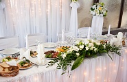 Стол для молодых украшен тканью, свечами, цветами и гирляндами - 100$
